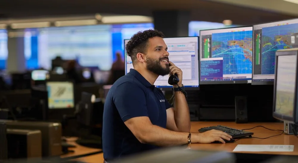 A flight support coordinator at a workstation